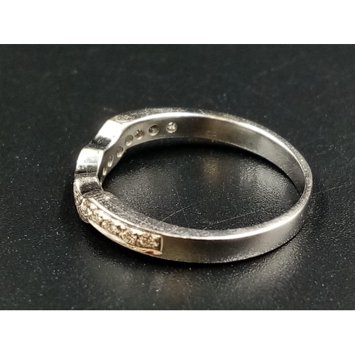 1010 - An 18k White Gold Diamond Half-Eternity Ring. Size L.
2.5g.