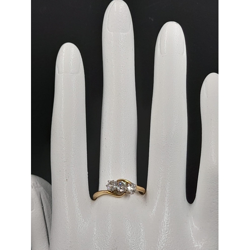 450 - An 18K Yellow Gold Three Diamond Ring. 0.75ct. Size P.
2.3g