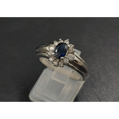 1238 - An 18K White Gold Diamond and Sapphire Ring. Centre stone sapphire surrounded by a halo of diamonds.... 