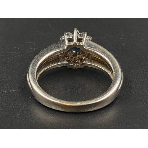 1238 - An 18K White Gold Diamond and Sapphire Ring. Centre stone sapphire surrounded by a halo of diamonds.... 