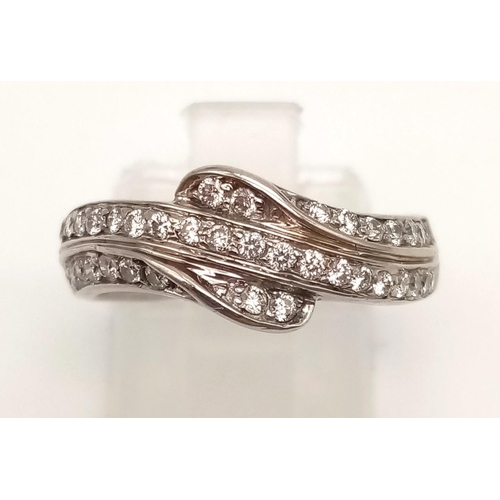 743 - An 18K White Gold Three-Row Diamond Half-Eternity Ring. Size N. 4.97g