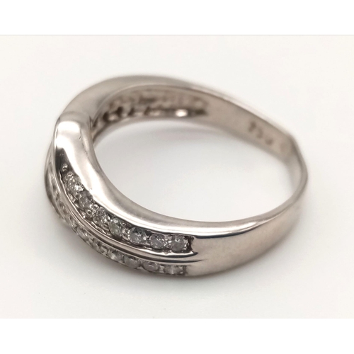 743 - An 18K White Gold Three-Row Diamond Half-Eternity Ring. Size N. 4.97g