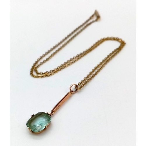 1118 - An Antique 9K Yellow Gold Blue Topaz Pendant on a Yellow Metal Chain. Pendant - 1.6g.