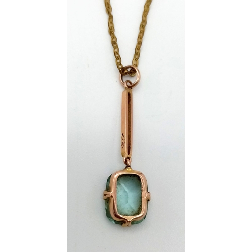 1118 - An Antique 9K Yellow Gold Blue Topaz Pendant on a Yellow Metal Chain. Pendant - 1.6g.