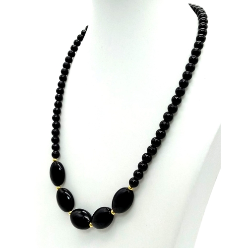 1402 - A Black Agate Bead Necklace with Oval Bead Decoration. 44cm