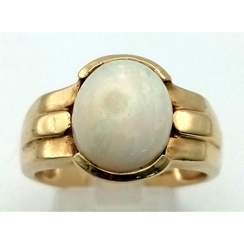 227 - A Vintage 9K Yellow Gold Opal Ring. High quality central opal cabochon. Size T. 6.5g total weight.