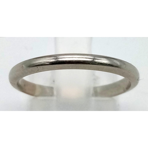 530 - An 18K White Gold Band Ring. Size N/O. 2.38g