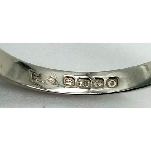 530 - An 18K White Gold Band Ring. Size N/O. 2.38g