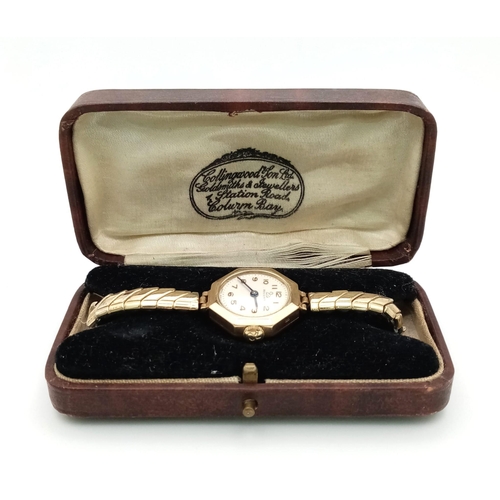 580 - A Vintage 9K Yellow Gold Cased Record Ladies Watch. Expandable gold plated strap. Octagon case. Mech... 