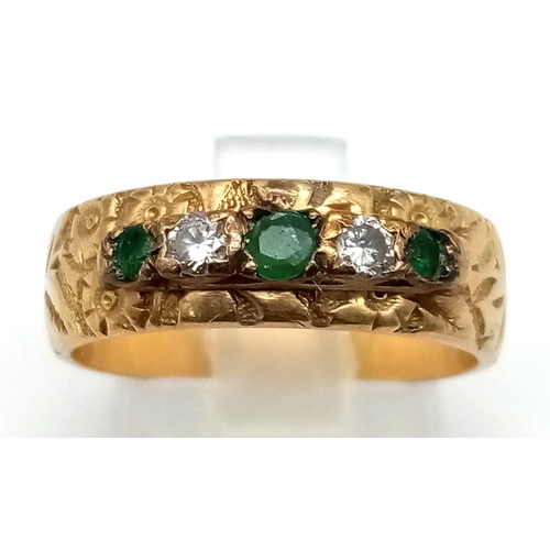 79 - A Vintage 18K Yellow Gold Emerald and Diamond Five Stone Ring. Decorative band with three emeralds a... 