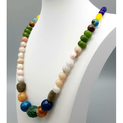 942 - An Emerald, Jade and Onyx Multi-Coloured Beaded Necklace. With also amethyst, tiger eye, opal and la... 