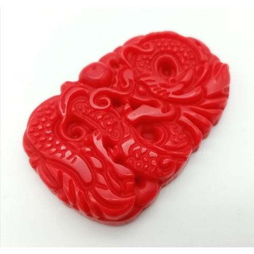 967 - A Red Jade Dragon Pendant. 5cm.