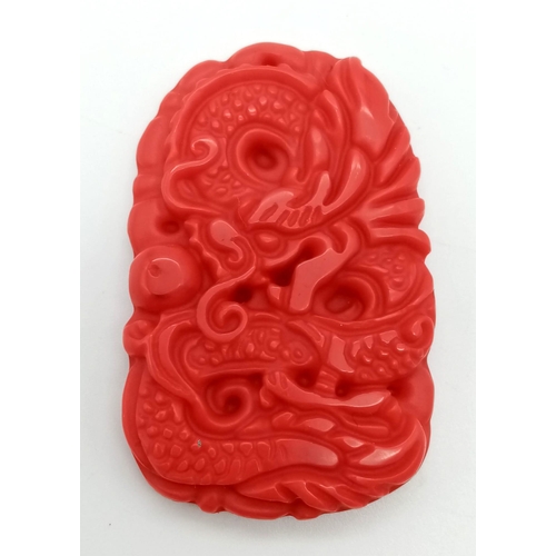 967 - A Red Jade Dragon Pendant. 5cm.