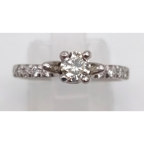 403 - A Platinum and Diamond Ring. Central diamond with diamonds on shoulders. 0.35 and 0.25ct. Size L.
4.... 