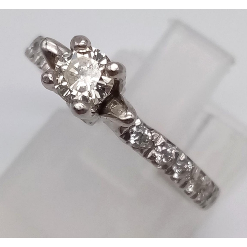 403 - A Platinum and Diamond Ring. Central diamond with diamonds on shoulders. 0.35 and 0.25ct. Size L.
4.... 