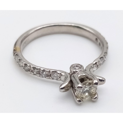 403 - A Platinum and Diamond Ring. Central diamond with diamonds on shoulders. 0.35 and 0.25ct. Size L.
4.... 