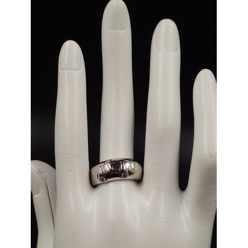 478 - A 14K White Gold Four Champagne Diamond Band Ring.
Size Q. 5.6g