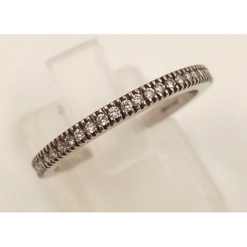 855 - A 14k White Gold Diamond Half-Eternity Ring. 1.86g.
Size M.