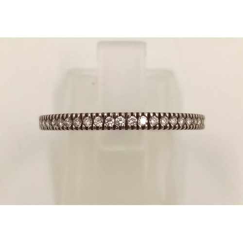 855 - A 14k White Gold Diamond Half-Eternity Ring. 1.86g.
Size M.