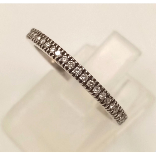 855 - A 14k White Gold Diamond Half-Eternity Ring. 1.86g.
Size M.