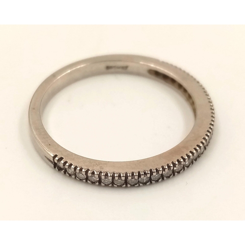 855 - A 14k White Gold Diamond Half-Eternity Ring. 1.86g.
Size M.