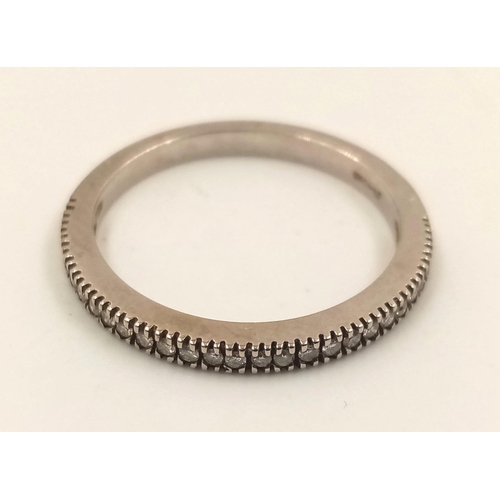 855 - A 14k White Gold Diamond Half-Eternity Ring. 1.86g.
Size M.