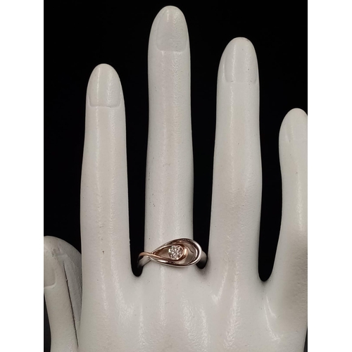 1136 - A 14K White and Rose Gold Solitaire Diamond Ring.
0.15ct. Size N. 3.38g