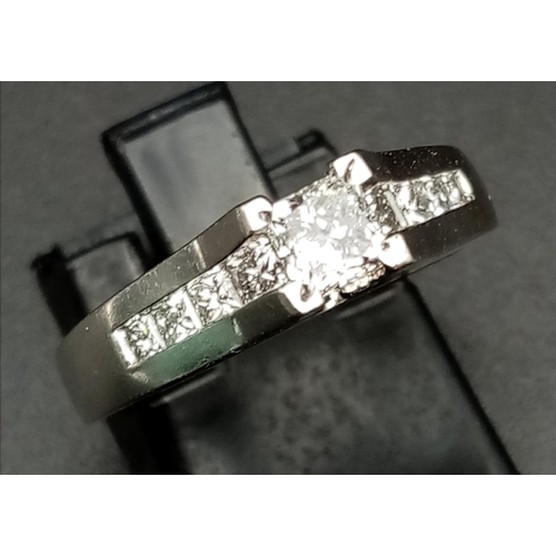 1052 - A 14K White Gold Diamond Ring. 0.50ct centre stone with a further .10ct on shoulders. Size N. 4.40g