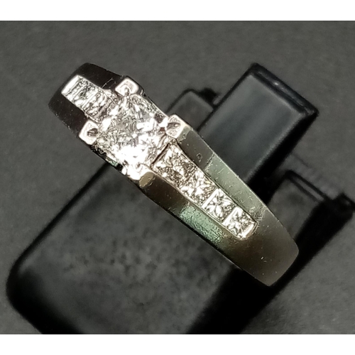 1052 - A 14K White Gold Diamond Ring. 0.50ct centre stone with a further .10ct on shoulders. Size N. 4.40g