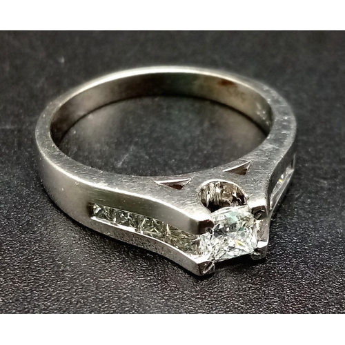 1052 - A 14K White Gold Diamond Ring. 0.50ct centre stone with a further .10ct on shoulders. Size N. 4.40g