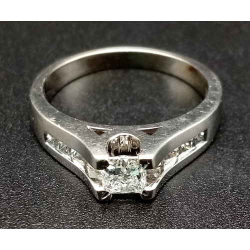 1052 - A 14K White Gold Diamond Ring. 0.50ct centre stone with a further .10ct on shoulders. Size N. 4.40g