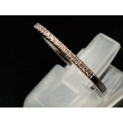 1143 - A 14k White Gold Diamond Half Eternity Ring. Size N. 1.9g