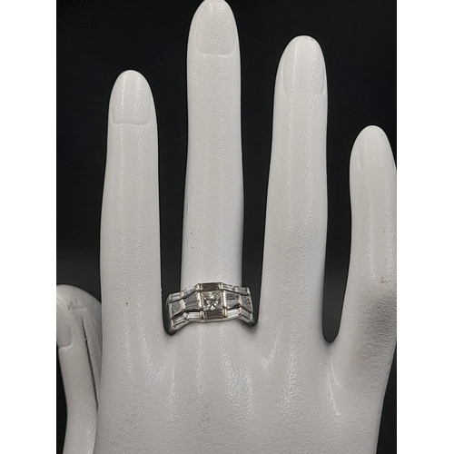 638 - A Modern 14K White Gold Diamond Band Ring - Central diamond with two bow-tie shaped diamonds either ... 