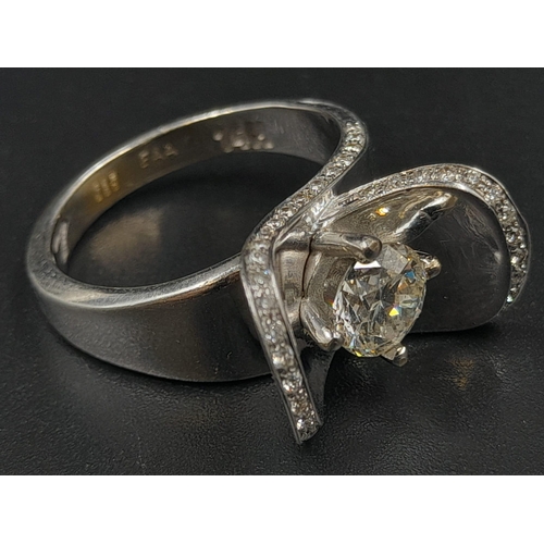 424 - A 14K White Gold Diamond Ring with Raised Diamond Shoulders. 0.90ct and 0.40ct. H-VS Grade. Size O. ... 