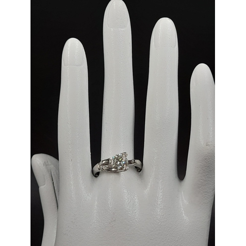 1155 - A 14K White Gold Diamond Ring - Round brilliant cut centre stone with diamond claw-effect surround. ... 