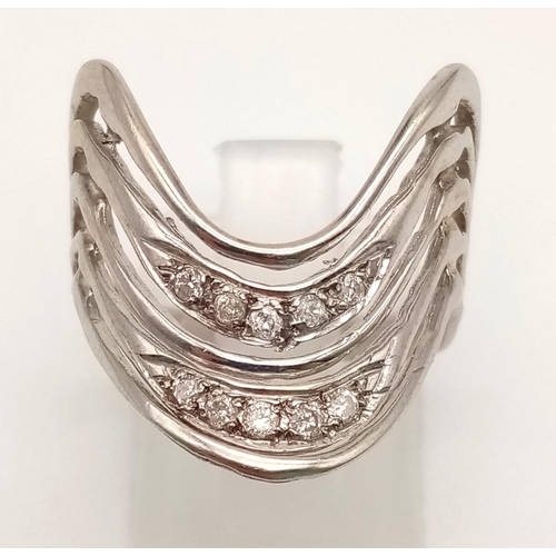 1038 - A 14K White Gold Diamond Chevron Ring. 0.30ct. Size O.
4.38g