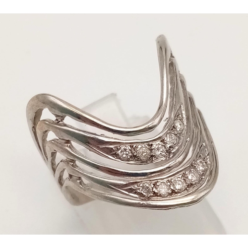 1038 - A 14K White Gold Diamond Chevron Ring. 0.30ct. Size O.
4.38g