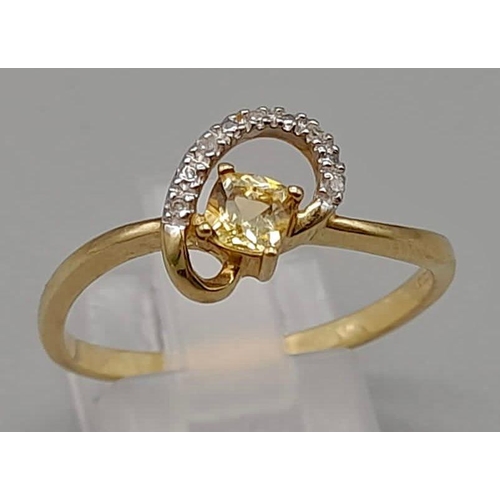 1045 - A 9K Yellow Gold Ring with Centre Yellow Stone and surrounded by wave of Diamond. Size U/T
Total wei... 