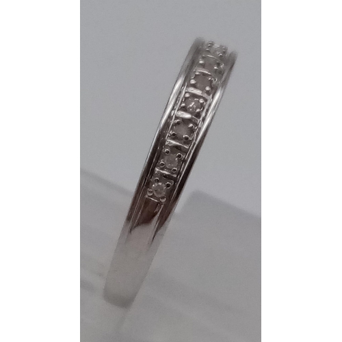 694 - A 9K White Gold Diamond 1/2 Eternity Ring. Size O. 
Total weights: 1.32g.