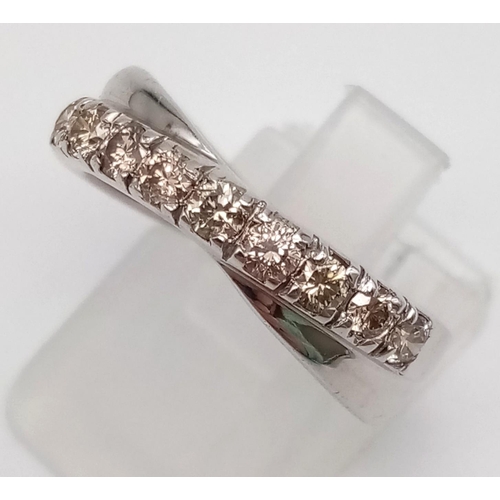 1252 - A 9K White Gold Twist Half-Eternity Diamond Ring. 0.60ct. Size N. 3.77g