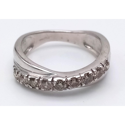 1252 - A 9K White Gold Twist Half-Eternity Diamond Ring. 0.60ct. Size N. 3.77g