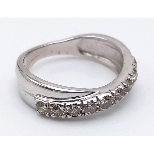 1252 - A 9K White Gold Twist Half-Eternity Diamond Ring. 0.60ct. Size N. 3.77g