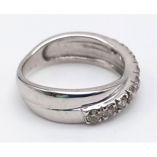 1252 - A 9K White Gold Twist Half-Eternity Diamond Ring. 0.60ct. Size N. 3.77g