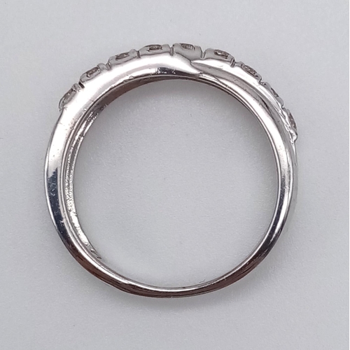 1252 - A 9K White Gold Twist Half-Eternity Diamond Ring. 0.60ct. Size N. 3.77g