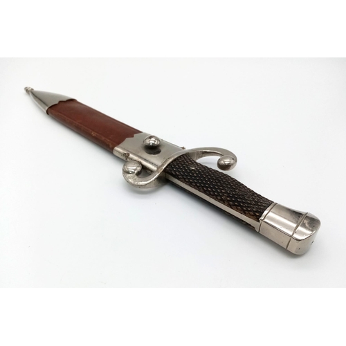 654 - A Vintage Toledo Dagger with Scabbard. In good condition but please see photos. 33cm total length.