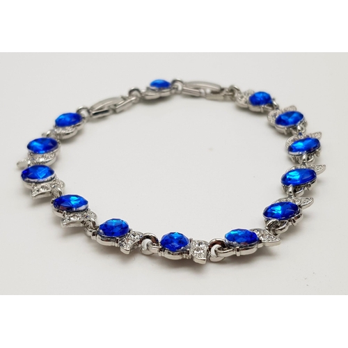 908 - A Ruby Red and Sapphire Blue Coloured Stone Bracelet set in White Metal. Both with expandable links ... 