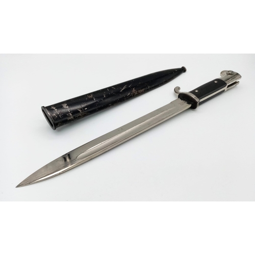 911 - A German Third Reich Dress Bayonet by WKC with Scabbard.
Makers mark on blade. Total length - 39cm