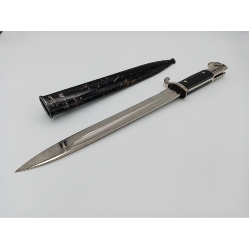 911 - A German Third Reich Dress Bayonet by WKC with Scabbard.
Makers mark on blade. Total length - 39cm