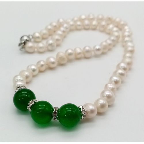 955 - An Akoya Freshwater Pearl and Green Jade Bead Necklace.
Silver tone clasp. 44cm