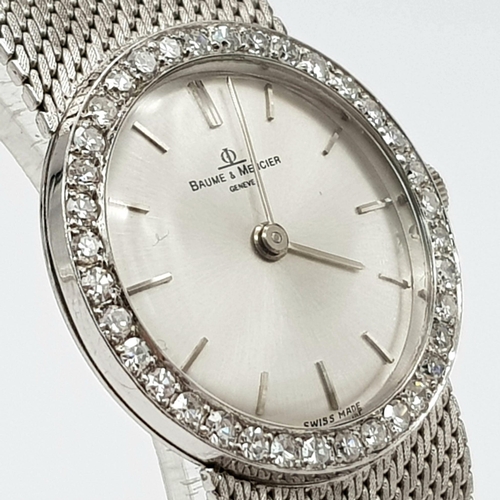 459 - A Baume and Mercier 18K White Gold and Diamond Watch. 18k gold strap and case - 25mm. Diamond bezel.... 